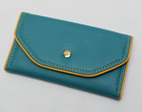 Slim Tri-fold wallet in teal vinyl with sunflower yellow piping, vinyl interior card slots and cotton lining
